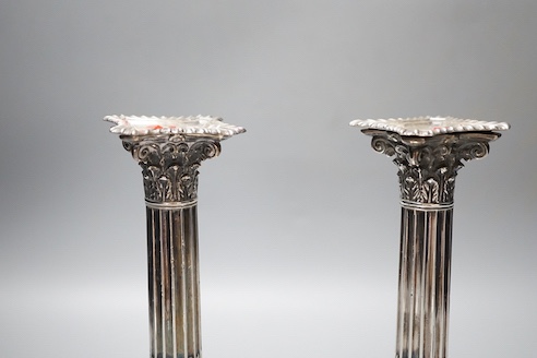 A pair of late Victorian silver Corinthian column candlesticks, Hawksworth, Eyre & Co, Sheffield, 1890, 21.6cm, weighted, sconce a.f.